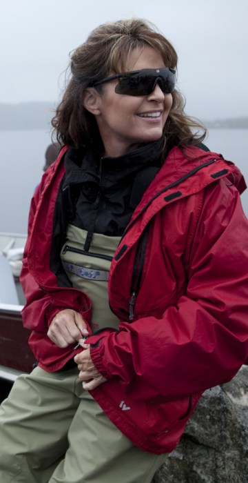 DILLINGHAM, ALASKA -JULY 02 2010: Sarah Palin ready to head up the river in Todd's boat to go see the fish counting (where a Fish & Game official regulates the fishing open and closed hours by counting the fish coming up the river)  in Dillingham, where Todd salmon fishes every year in July, and where the Palin family usually spend 4th of July.